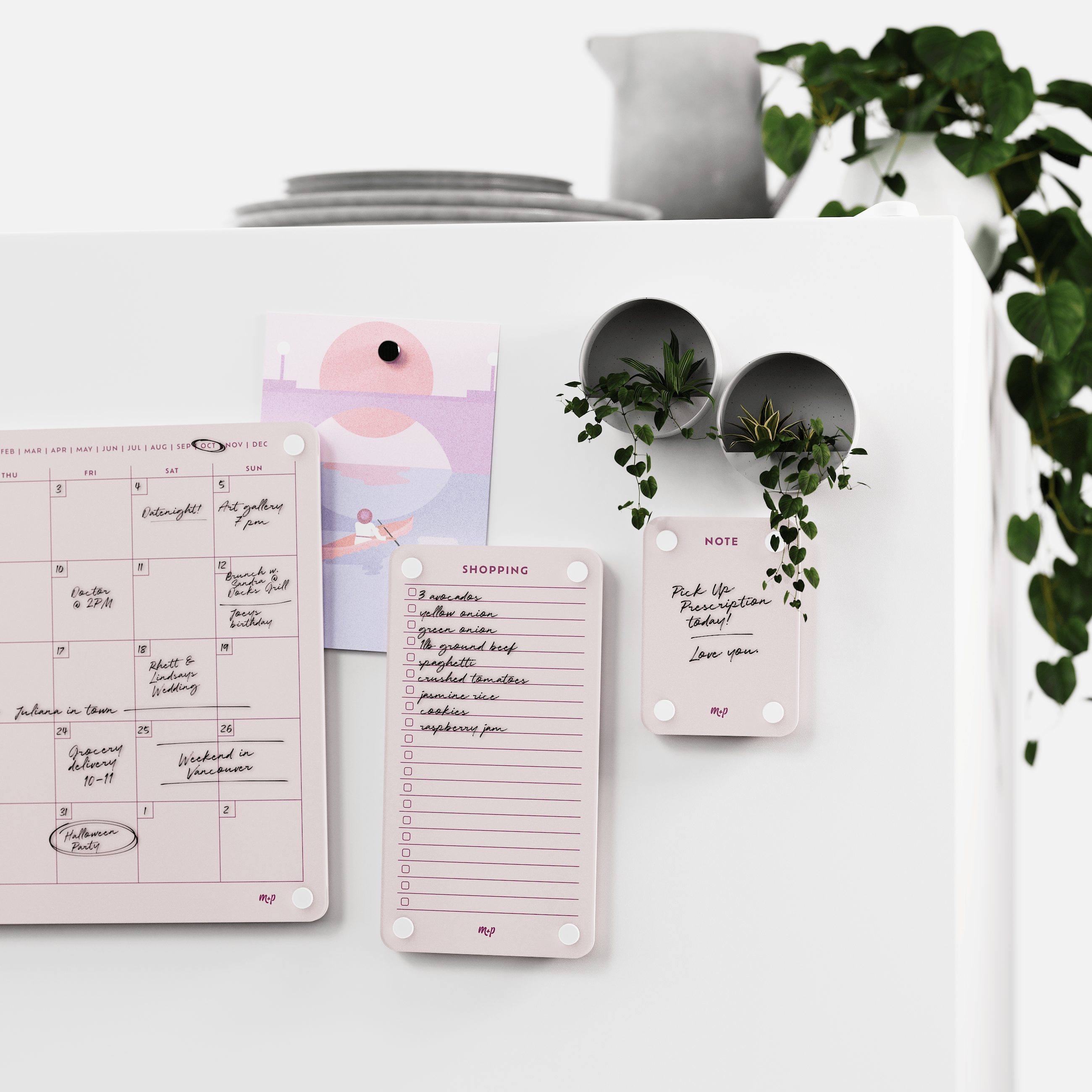 Linen white calendar, shopping list and note board on a white wall beside two magnetic planters
